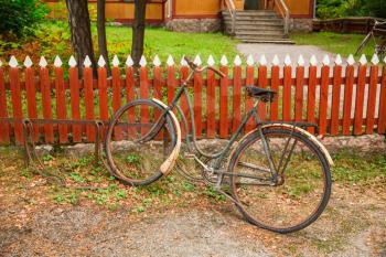 Old bicycle at the fence.