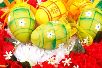 Easter eggs decoration on artificial flowers nest.