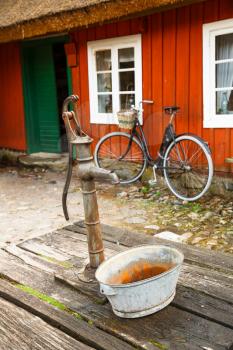 Traditional old water tap in rural backyard at Skansen, the first open-air museum and zoo, located on the island Djurgarden.