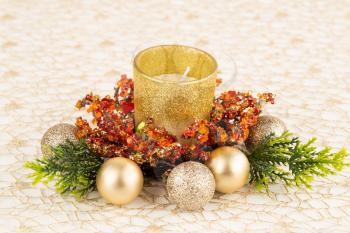 Christmas decoration with candle and balls on the golden net.