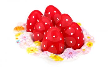 Easter eggs on ceramic setting isolated on white background.