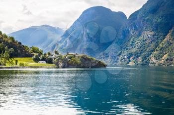 Landscape with Naeroyfjord, mountains and traditional village houses in Norway.