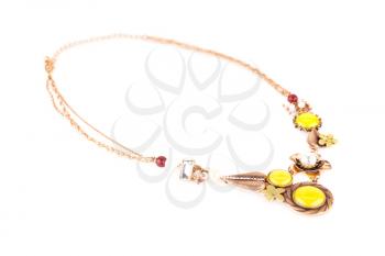 Stylish necklace with yellow stones and pearls isolated on white background.