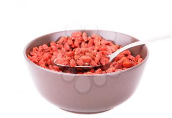 Goji berries in brown bowl isolated on white background.