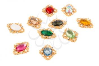 Cabochons with colorful rhinestones isolated on white background.