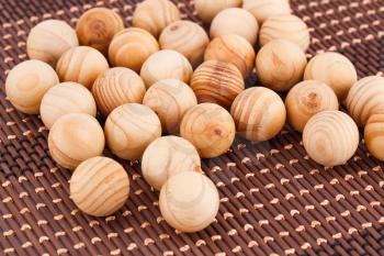 Wooden balls on bamboo background.