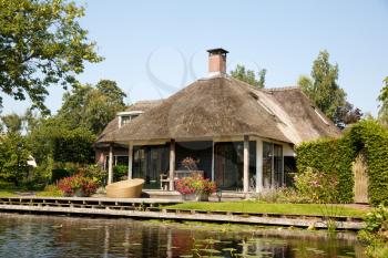 The thatched roof house with beatiful garden in fairytale village Giethoorn in The Netherlands.