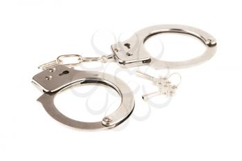 Handcuffs and keys isolated on a white background.
