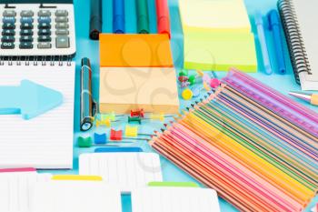 Back to school, stationary on blue background.