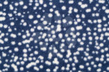 Blue fabric with white spots as a background.