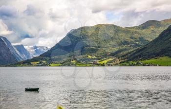 Landscape with mountains, fjord and village in Norway.