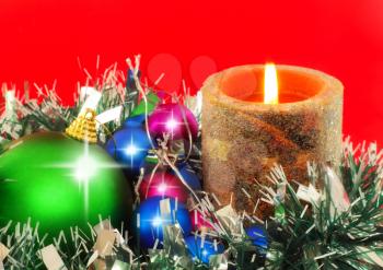 Christmas and New Year decoration-balls and candels on red background .