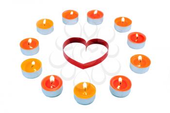 Single heart , surrounded small candles light .