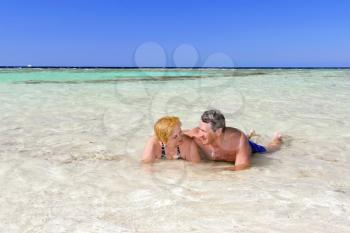 Mature couple on the beach in the tropical resort.