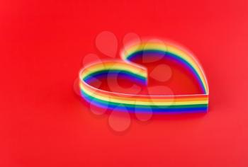 St. Valentine Day. Single heart , paint of a six-colour gay flag. On red.