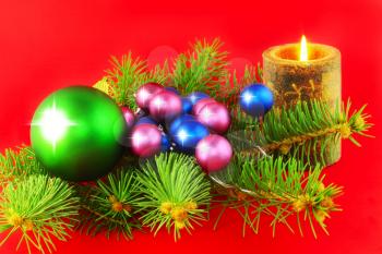 Christmas and New Year decoration-balls and candels on red background .