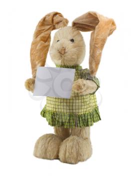Straw rabbit with blank card in hands . Isolated