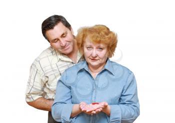 Old couple, wife hold  a small heart. Isolated over white