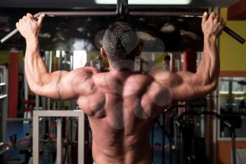 Muscular Man Exercising In Gym