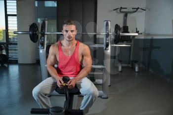 Sporty Man Resting In A Gym