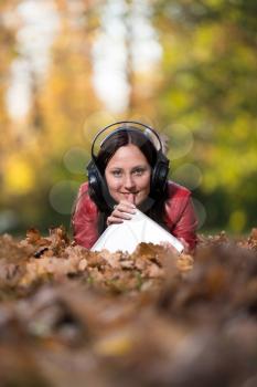 Smiling Female Listening To Music Autumn