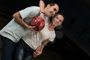 Couple Embracing At The Bowling Alley