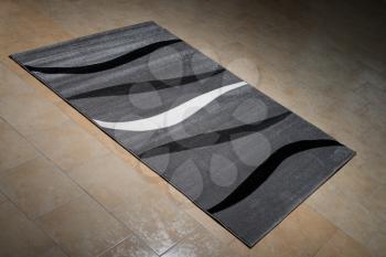 Black Pattern Carpet Lying On Floor