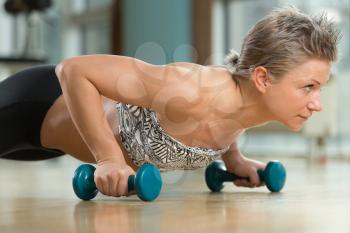 Beautiful Fit Woman Doing Push-ups In Healthy Club