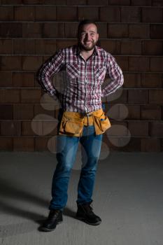 Portrait Of Handsome Builder With Tools
