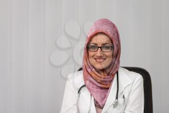 Muslim Doctor Relaxes Sitting In The Office