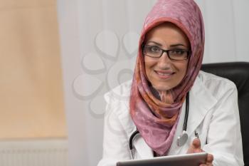 Muslim Doctor On A Break With His Touchpad