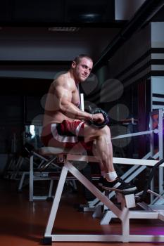 Male Bodybuilder Doing Heavy Weight Exercise For Legs