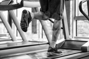 Close Up Of Male Legs Running On Treadmill - Blurred Motion