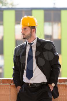 Portrait Of Business Man With Yellow Helmet On Construction