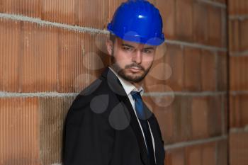 Portrait Of Business Man With Blue Helmet On Construction