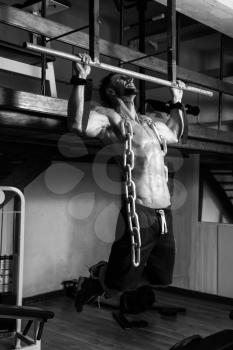Bodybuilder Doing Heavy Weight Exercise For Back With Chains