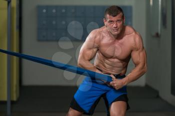 Muscular Man Training Stretching With Fitness Rubber Bands