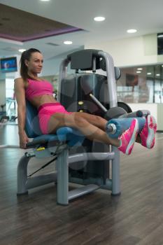 Young Woman Working Out Legs On Machine In A Gym - Leg Exercise