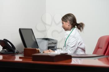 Young Pretty Female Doctor With Computer In The Office - Successful Woman Doc At Work