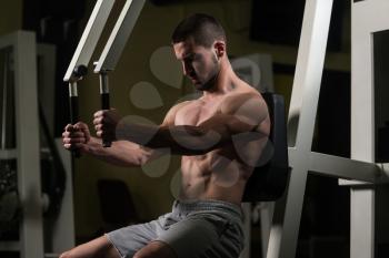 Young Bodybuilder Doing Heavy Weight Exercise For Chest On Machine