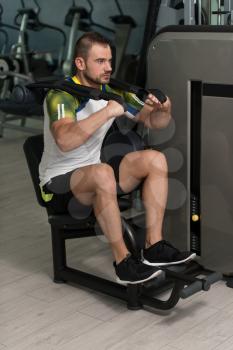 Attractive Man Doing Heavy Weight Exercise For Abdominal Abs On Machine
