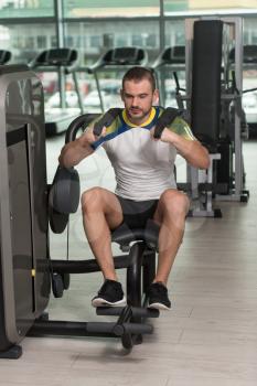 Attractive Man Doing Heavy Weight Exercise For Abdominal Abs On Machine