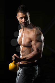 Healthy Man Exercising With Kettle Bell And Flexing Muscles - Muscular Athletic Bodybuilder Fitness Model Exercises