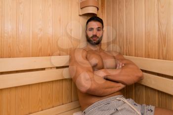 Happy Good Looking And Attractive Young Man With Muscular Body Relaxing In Hot Sauna