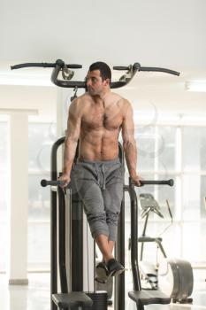 Hairy Muscular Fitness Bodybuilder Doing Heavy Weight Exercise For Triceps And Chest on Parallel Bars In The Gym