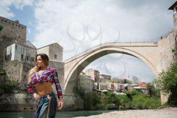 Portrait Of A Physically Fit Woman Showing Her Well Trained Body Outdoors Under The Bridge