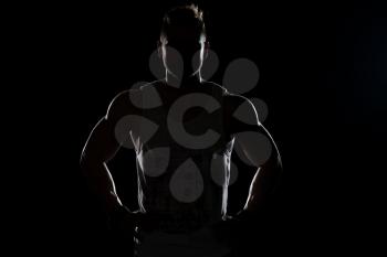 Silhouette Muscular Man Posing On Isolated On Black Background