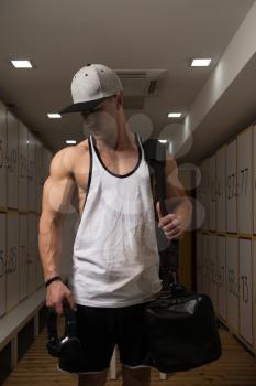 Young Fit Adult Man Changing Clothings In Locker Room Of Gym Facility