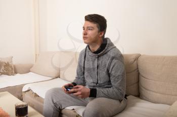 Young Man Is Focused on Playing Video Games At Home