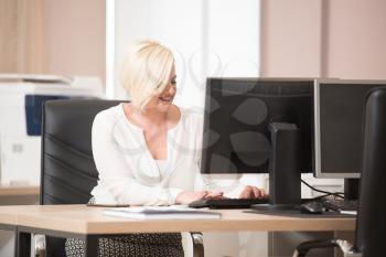 Portrait Of A Young Business Woman Using A Computer In The Office